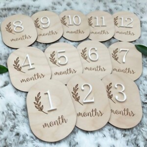 Personalized baby milestone discs engraved on wood